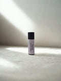 tallow and shea lip balm on a textured surface with soft lighting