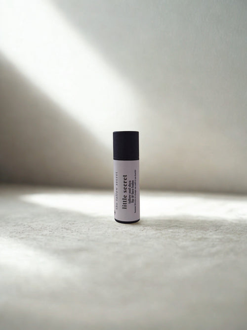 tallow and shea lip balm on a textured surface with soft lighting